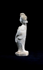 A WHITE MARBLE FIGURE OF A COURTESAN