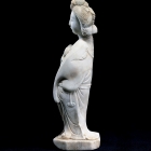 A WHITE MARBLE FIGURE OF A COURTESAN