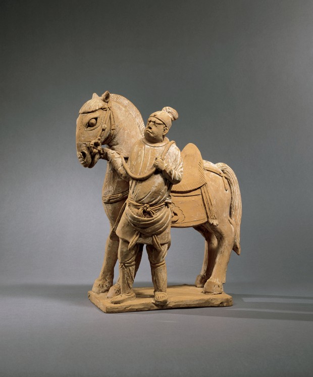 A RED POTTERY GROUP OF A HORSE AND GROOM