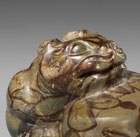 A PUDDINGSTONE TIGER-FORM MAT WEIGHT