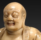 A SOAPSTONE FIGURE OF BUDAI