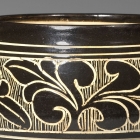 A CARVED ‘BLACK- AND WHITE’-GLAZED CIZHOU STONEWARE BOWL