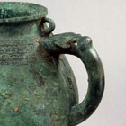 A BRONZE TRIPOD POURING VESSEL (HE)