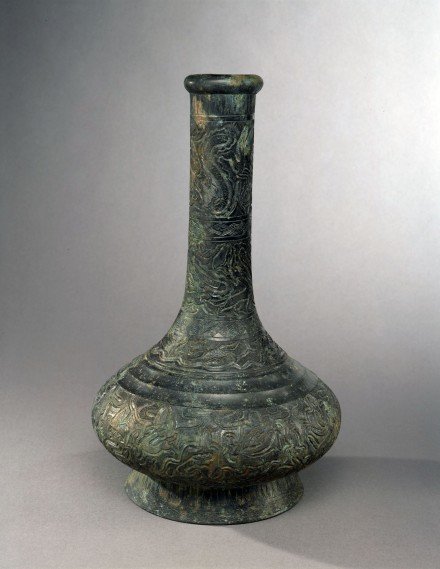 A BRONZE VASE WITH ENGRAVED DECORATION