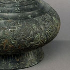 A BRONZE VASE WITH ENGRAVED DECORATION