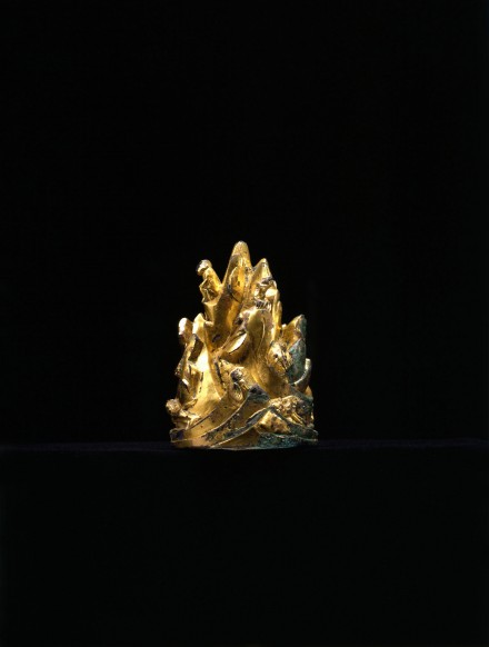 A GILT BRONZE MOUNTAIN-FORM WEIGHT