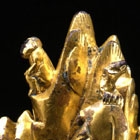 A GILT BRONZE MOUNTAIN-FORM WEIGHT