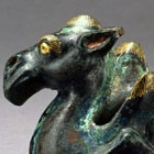 A GOLD- INLAID BRONZE CAMEL-FORM WEIGHT