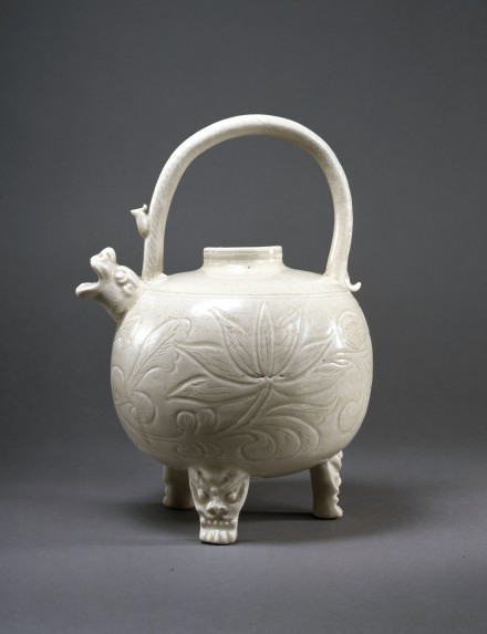 A CARVED WHITE PORCELAIN TRIPOD EWER