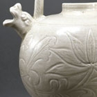 A CARVED WHITE PORCELAIN TRIPOD EWER