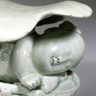 A YINGQING PORCELAIN ‘BOY AND LILYPAD’ PILLOW