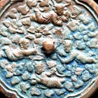 A BRONZE ‘BOYS AND FLOWERS’ MIRROR