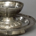 A SILVER FLOWER-SHAPED WINECUP AND STAND