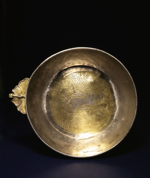 A CHASED AND PARCEL-GILT SILVER BOWL WITH FLANGE HANDLE