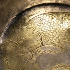 A CHASED AND PARCEL-GILT SILVER BOWL WITH FLANGE HANDLE