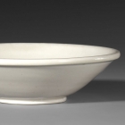 A SHALLOW BOWL ON ‘BI-DISC’ FOOT