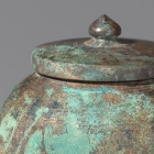 A SMALL BRONZE COVERED JAR