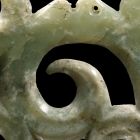 A NEOLITHIC JADE OPENWORK HOOKED CLOUD FORM PENDANT
