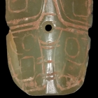 A JADE BOVINE MASK FORM ORNAMENT