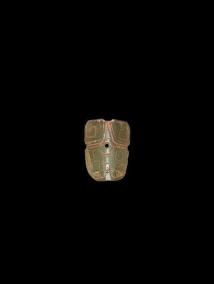 A JADE BOVINE MASK FORM ORNAMENT