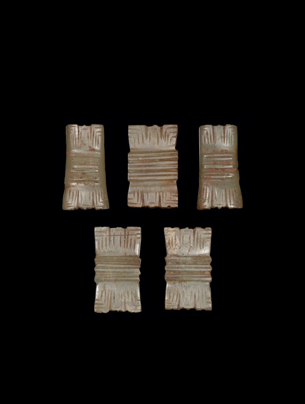 FIVE JADE PLAQUES OF ‘TIED BUNDLE’ FORM