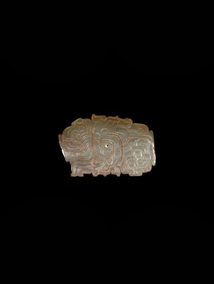 A JADE ORNAMENT WITH ENTWINED HUMAN HEADS AND DRAGONS DESIGN