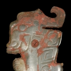 A JADE ORNAMENT CARVED WITH A HUMAN FACE