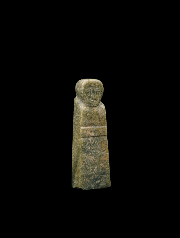 A MOTTLED GREEN JADE STANDING FIGURE