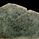 AN INCISED GREEN JADE PLAQUE