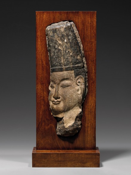 A LIMESTONE RELIEF HEAD OF A DIGNITARY