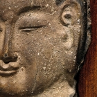 A LIMESTONE RELIEF HEAD OF A DIGNITARY