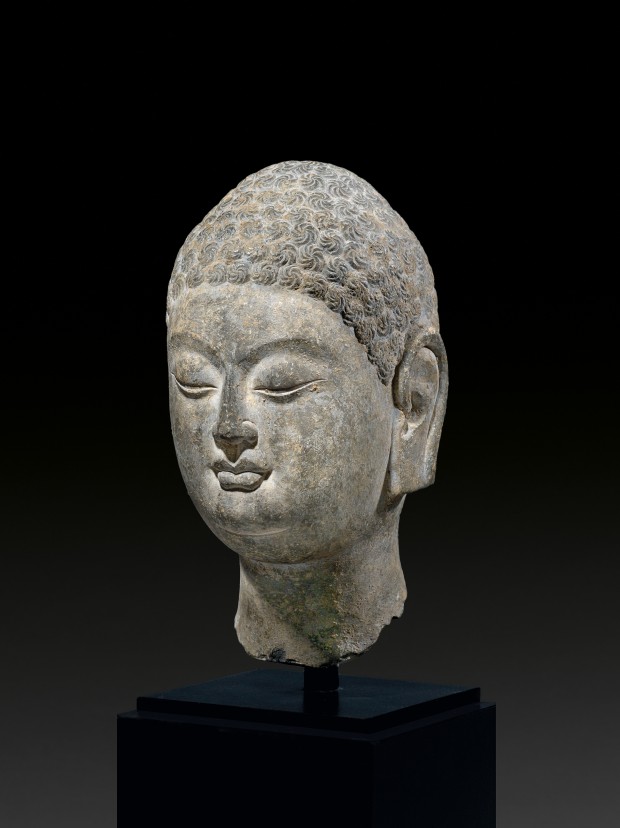 A LIMESTONE HEAD OF BUDDHA