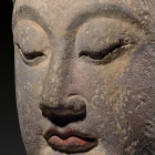 A LARGE SANDSTONE HEAD OF A BODHISATTVA