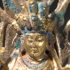 A GILT BRONZE FIGURE OF ELEVEN-HEADED GUANYIN