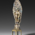 A GILT BRONZE FIGURE OF ELEVEN-HEADED GUANYIN