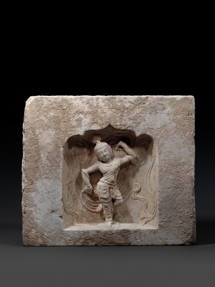 A LIMESTONE BLOCK WITH DANCER IN A NICHE