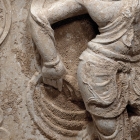 A LIMESTONE BLOCK WITH DANCER IN A NICHE