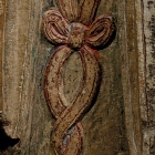 A PAINTED MARBLE FIGURE OF AN ATTENDANT DEITY