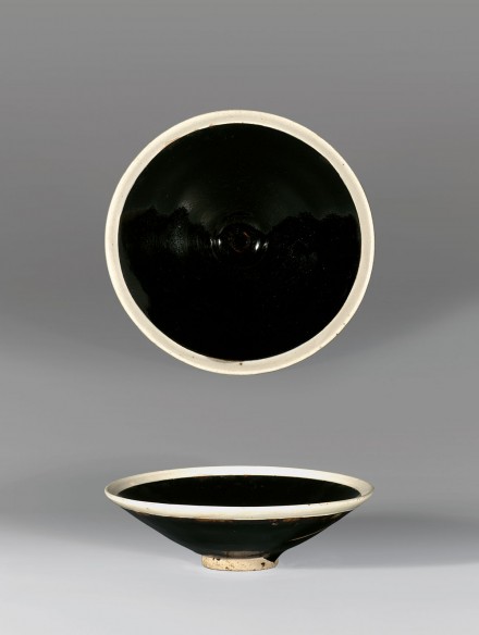 A BLACK-GLAZED CONICAL BOWL WITH WHITE RIM