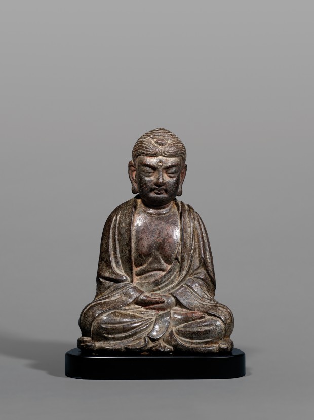 AN EARLY CAST IRON FIGURE OF AMITĀBHA