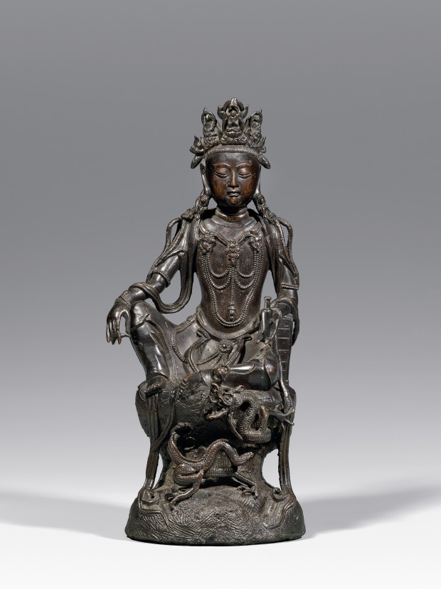 A BRONZE SEATED GUANYIN WITH A DRAGON