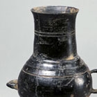 A NEOLITHIC BURNISHED BLACK POTTERY VESSEL WITH TWO HANDLES