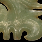 A NEOLITHIC JADE TOOTHED MASK ORNAMENT