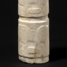 A CARVED NEOLITHIC JADE CYLINDRICAL BEAD