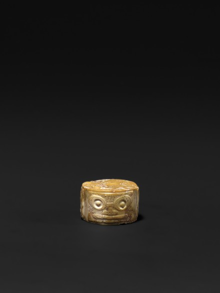 A NEOLITHIC JADE ORNAMENT CARVED WITH MASKS
