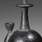 A BURNISHED BLACK POTTERY BUDDHIST RITUAL VESSEL (KUNDIKA)