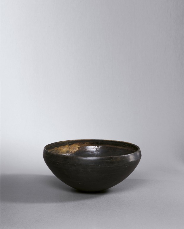 A BURNISHED BLACK POTTERY ALMS BOWL (PATRA)