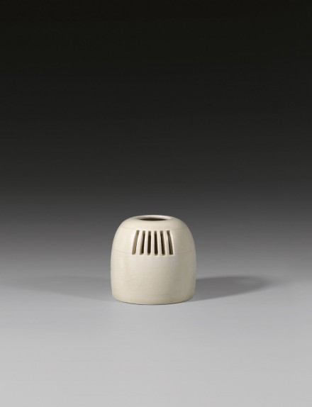 AN OPENWORK GLAZED WHITE STONEWARE CENSER