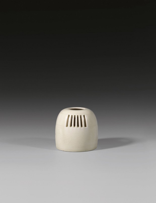 AN OPENWORK GLAZED WHITE STONEWARE CENSER