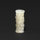 AN ARCHAIC JADE ‘GRAIN PATTERN’ BEAD